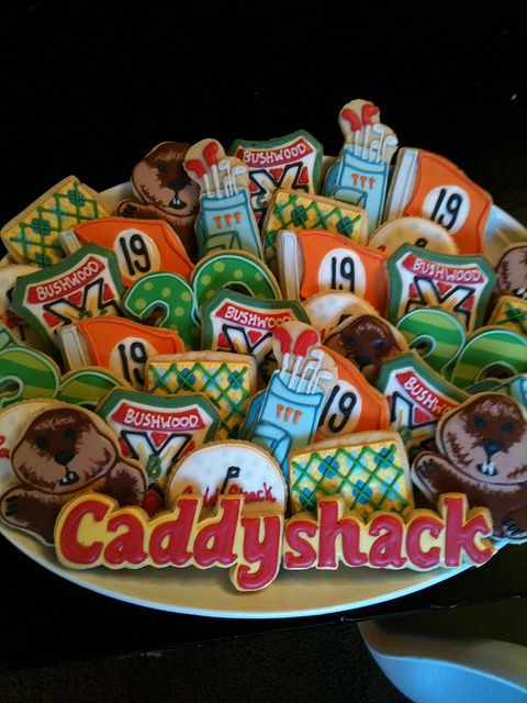 a plate full of cookies with the name caddyshack on it and some decorations