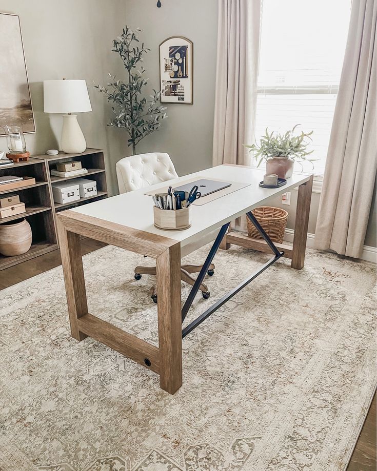 a living room with a large rug and a table in the middle of the room