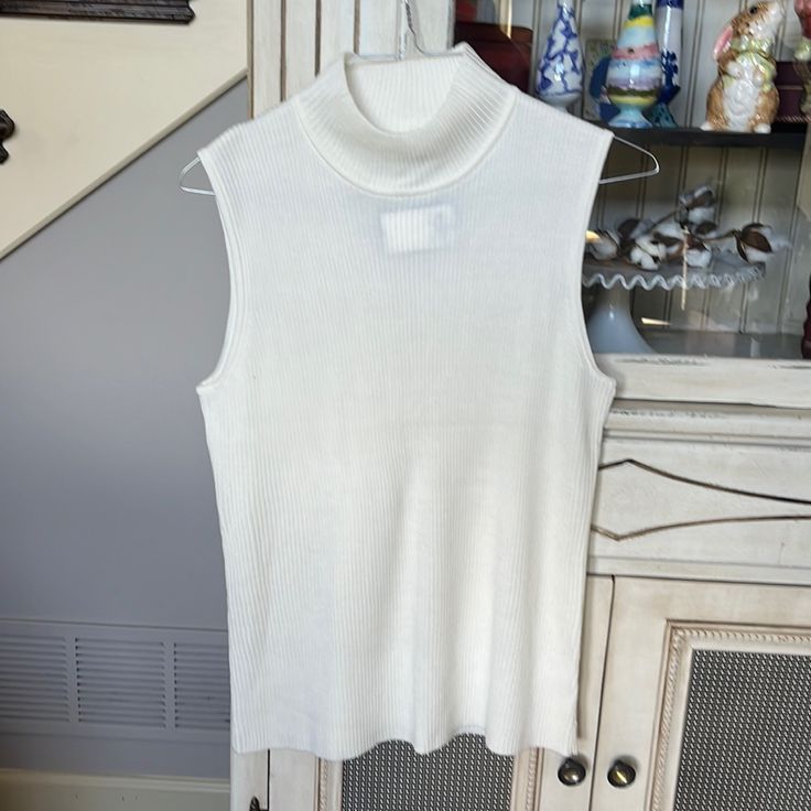 Ts A White Knitted Sleeveless Sweater That Is Brand New And Never Worn. It’s A Size Xl And White White Knit Tank Top For Layering, Fall Sleeveless Knitted Top, Sleeveless Knitted Fall Tops, White Sleeveless Knit Top For Winter, Knitted Sleeveless Fall Top, White Sleeveless Knit Top For Fall, White Tank Knit Top For Layering, White Sleeveless Sweater For Layering, White Knit Vest Top