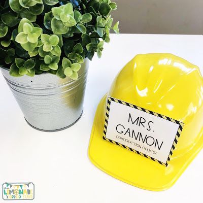 a potted plant sitting next to a yellow chair with a name tag on it