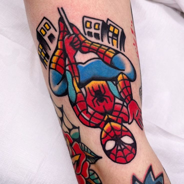 a spider man tattoo on the arm