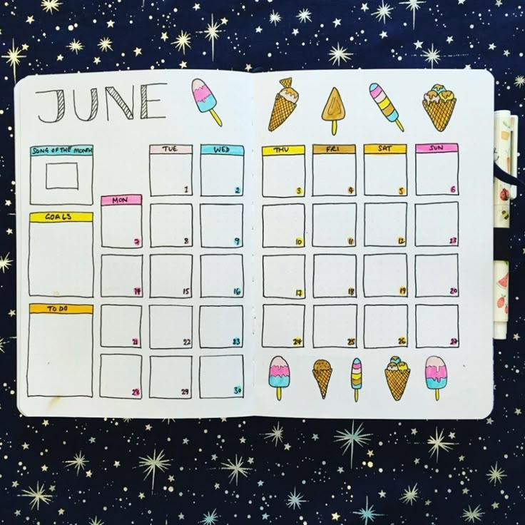 an open planner with ice cream cones and popsicles on it in the space between stars