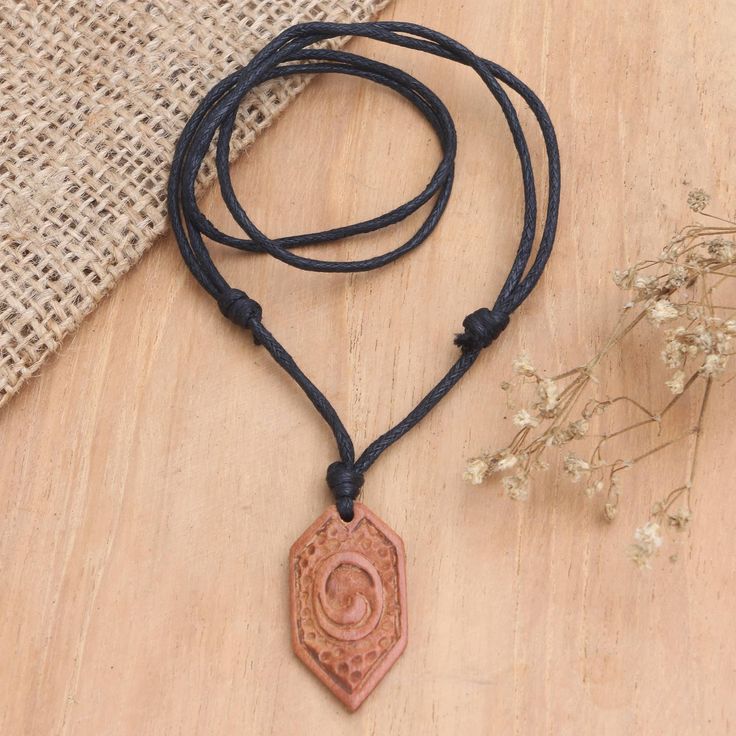 Who said men don't love fashion? Most of them will definitely find this exquisitely hand-carved wood necklace irresistible because it adds character to any outfit. Handcrafted by Indonesian artisan Komang Agus Saputra from sawo wood, the adjustable necklace features an abstract symbol on the pendant and a braided cotton cord. Rope Braided Wood Carved Mjonir Necklace, Brown Carved Amulet Necklaces, Wood Pendant Necklace, Lotus Necklace, Cow Bones, Bone Pendant, Wooden Necklace, Wood Necklace, Woodworking Ideas