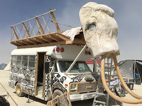 an elephant head is attached to the back of a truck