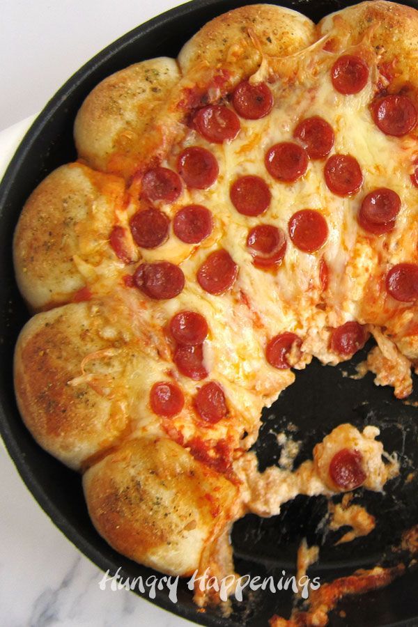 a pepperoni pizza in a cast iron skillet