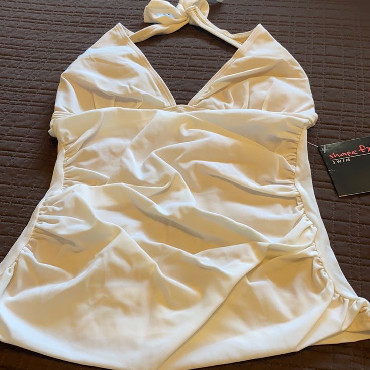 2 Piece White Tie Back Suit Brand New. White Sleeveless Tankini For Beach Season, White Halter Neck Tankini For Summer, White Lined Tankini For Summer, White Lined Summer Tankini, White Halter Neck Swimwear With Built-in Bra, White Halter Neck Tankini For Beach Season, Fitted White Swimwear With Built-in Bra, White Fitted Halter Neck Swimwear, White Halter Neck Tankini For Swimming