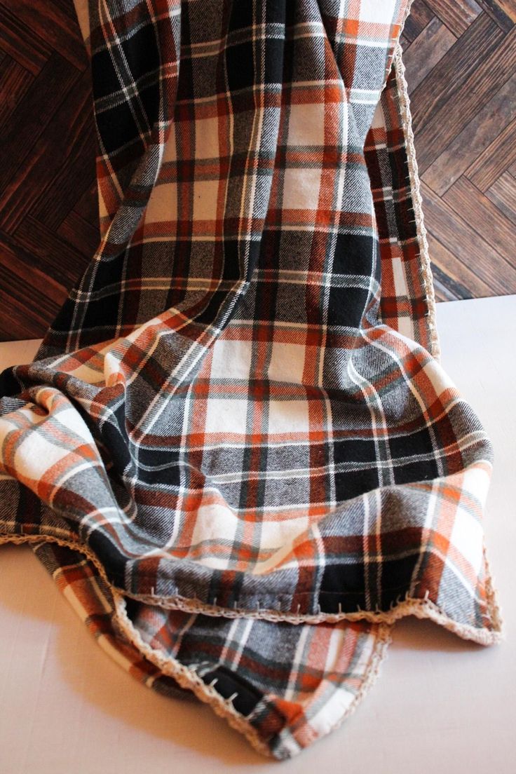 a plaid blanket is laying on the floor