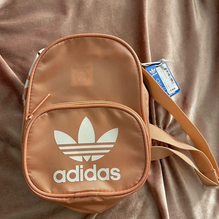 Brand New Adidas Backpack (Pink/Peach With White Logo) The Bag Is New With Tags Pink Crossbody Backpack For Daily Use, Trendy Adidas Shoulder Bag With Adjustable Strap, Pink Sporty Standard Backpack, Casual Pink Crossbody Backpack, Pink Adidas Backpack For Daily Use, Adidas Pink Backpack For Daily Use, Pink Adidas Travel Backpack, Trendy Adidas Shoulder Bag For Daily Use, Trendy White Adidas Bag