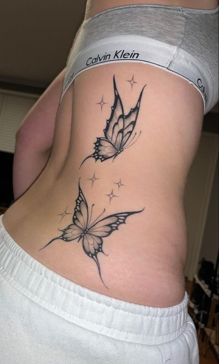 a woman with a butterfly tattoo on her stomach