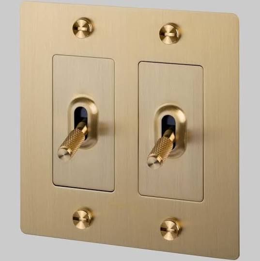 two light switch plates are shown with gold trim