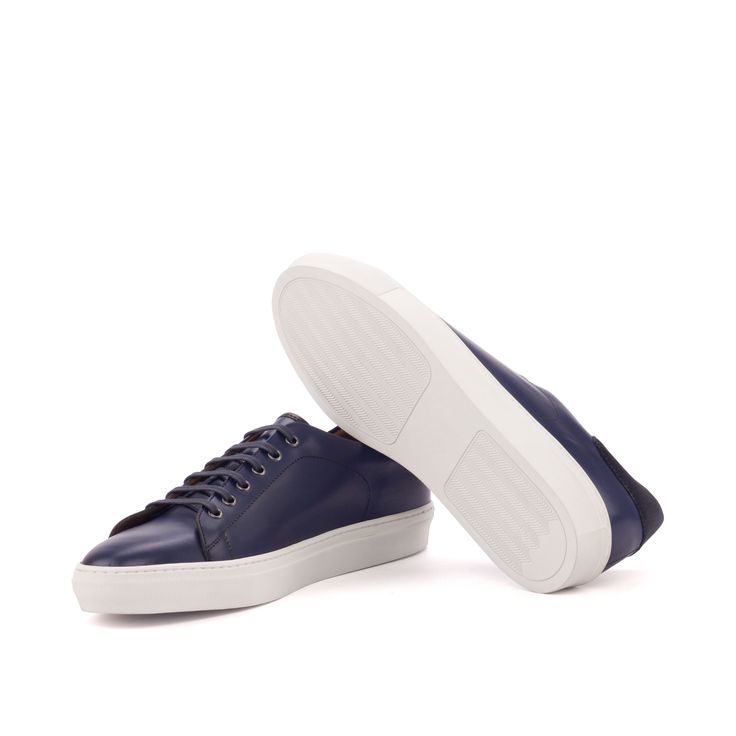 A classic men's sneaker, the cupsole trainer has never been more popular than it is now. Loved for its simple silhouette and comfortable design, the cupsole Trainer is both sleek and casual. Perfect for everyday wear, this shoe pairs well with jeans and other casual styles. The Details: Materials: navy box calf + navy lux suede + black painted calf Lining: tan calf leather Sole: white cupsole rubber sole The Fine Print: Shoe production timeline/shipping Can vary from 30-40 days from the date of Bryn Mawr, Perfect Sneakers, Brogue Boots, Custom Design Shoes, Custom Made Shoes, Mens Shoes Black, Casual Styles, Blue Box, Leather Trainers