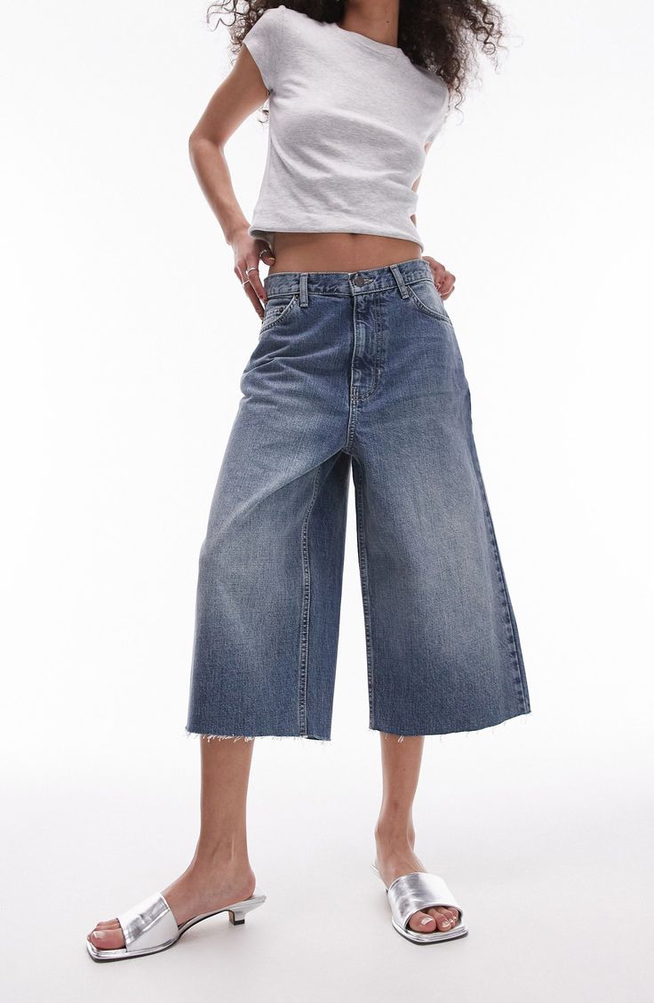 Update your denim for warm weather with trend-right, nonstretch capri jeans flaunting a low-rise waist, wide legs and raw hems. 18" inseam; 24" leg opening; 13 1/2" front rise; 16 1/2" back rise (size 8) Zip fly with button closure Five-pocket style 100% cotton Machine wash, dry flat Imported Ankle Grazer Jeans, Capri Jeans, Maxi Dress Trend, Swimwear Sale, Black Wrap Dress, Skirt Leggings, Hoodies For Sale, Petite Maternity, Plus Size Pregnancy