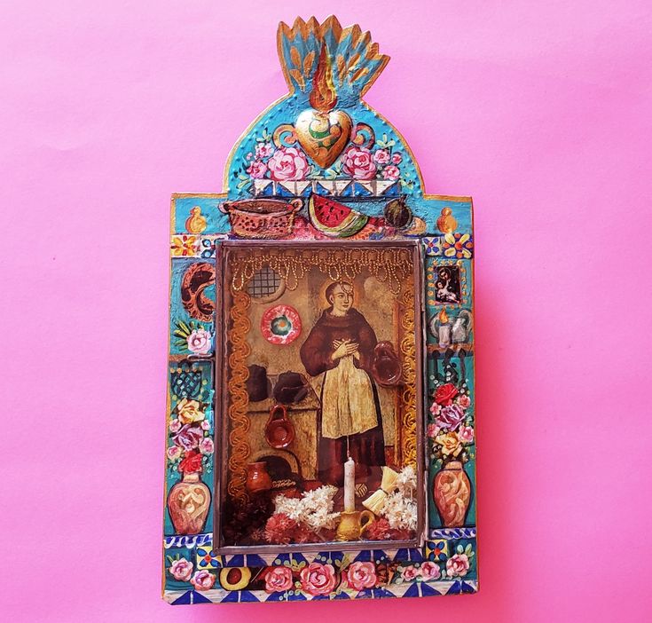 a painting on a pink wall with an ornate frame