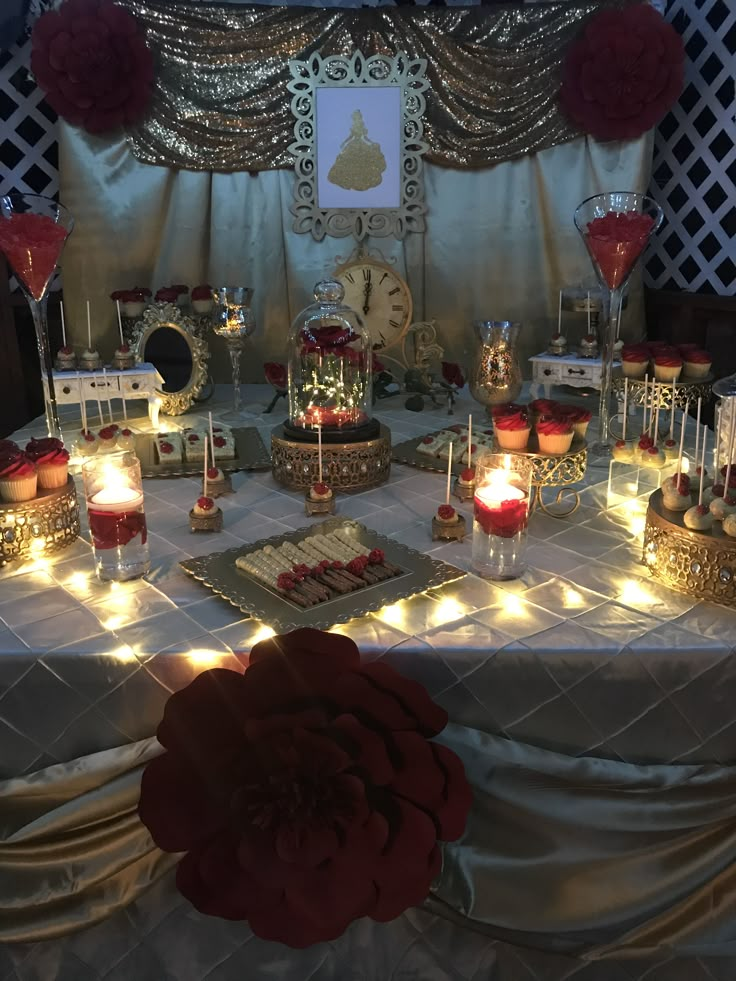 a table topped with lots of cakes and candles