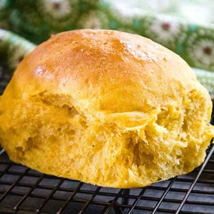 a loaf of bread sitting on top of a cooling rack next to a glass container