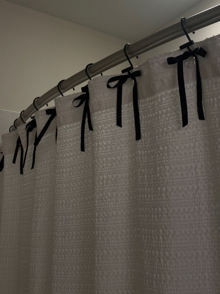 a shower curtain with black ribbon on it