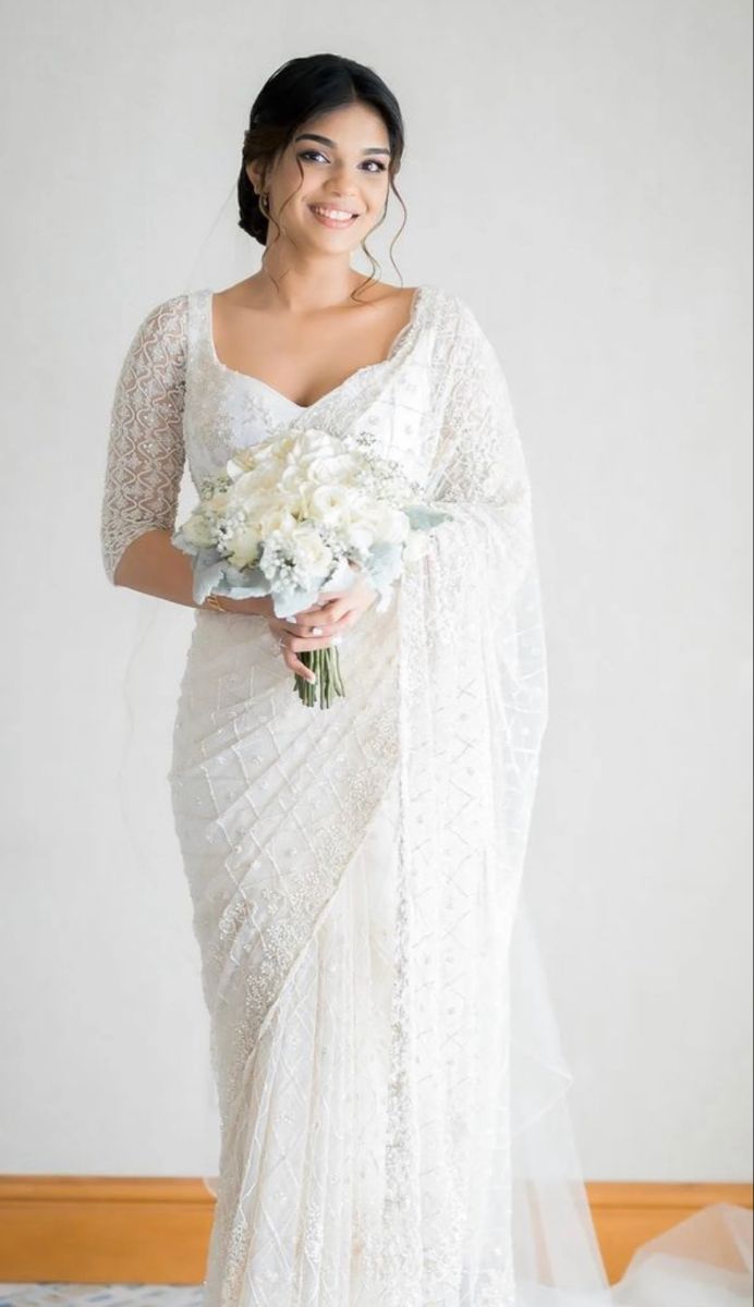 a woman in a white dress holding a bouquet of flowers