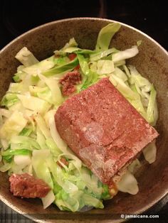 a bowl filled with meat and vegetables on top of a stove