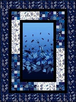 a blue and white quilt with birds flying over the water in it's center