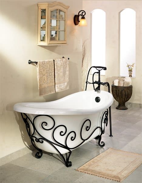 a white bath tub sitting inside of a bathroom next to a rug on the floor