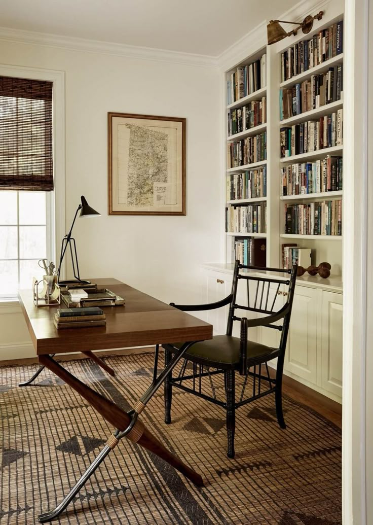 a room with a desk, chair and bookshelf