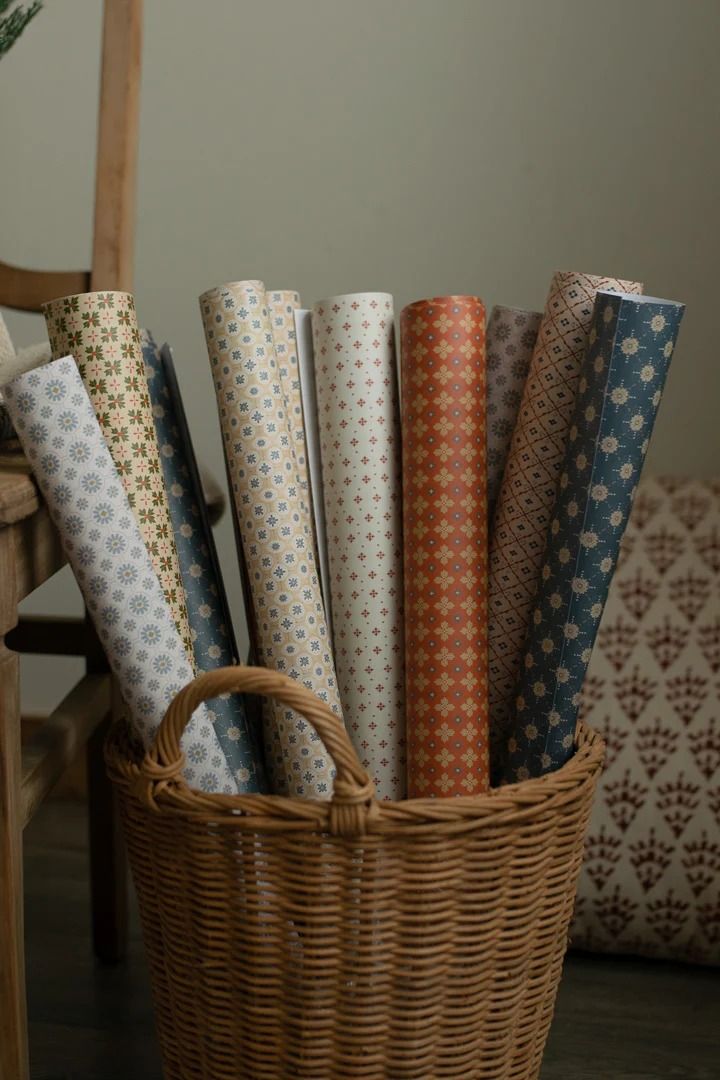 a basket filled with different types of wrapping paper