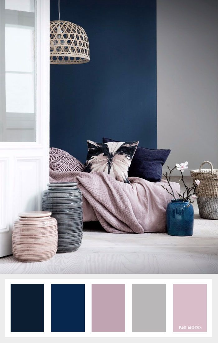 a living room with blue walls and white trimmings, including pink and grey accents