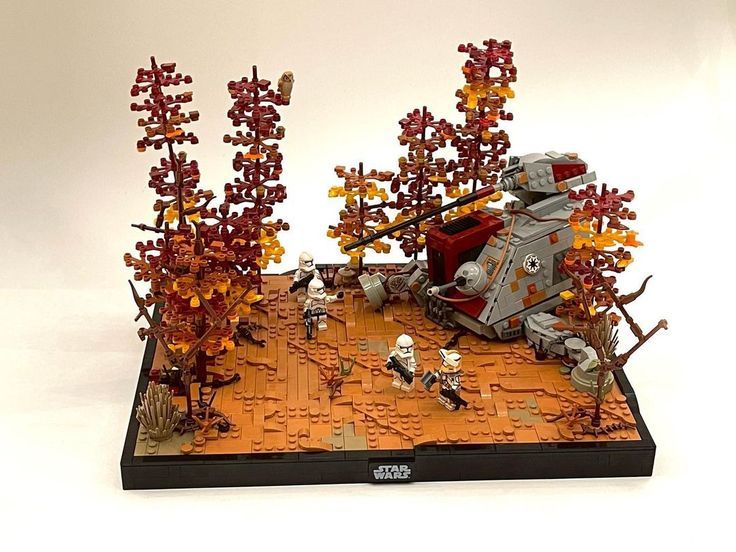 a lego star wars battle scene is displayed on a white surface with red and orange trees