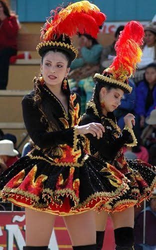 two women dressed in colorful costumes and headdress