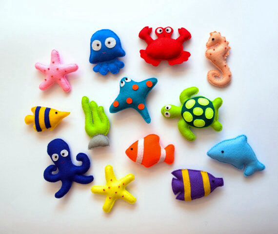 there are many different sea animals on the table together and one is blue, red, yellow, green, orange