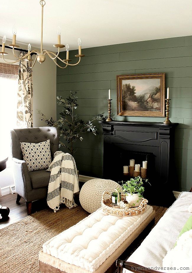 a living room filled with furniture and a fire place next to a painting on the wall