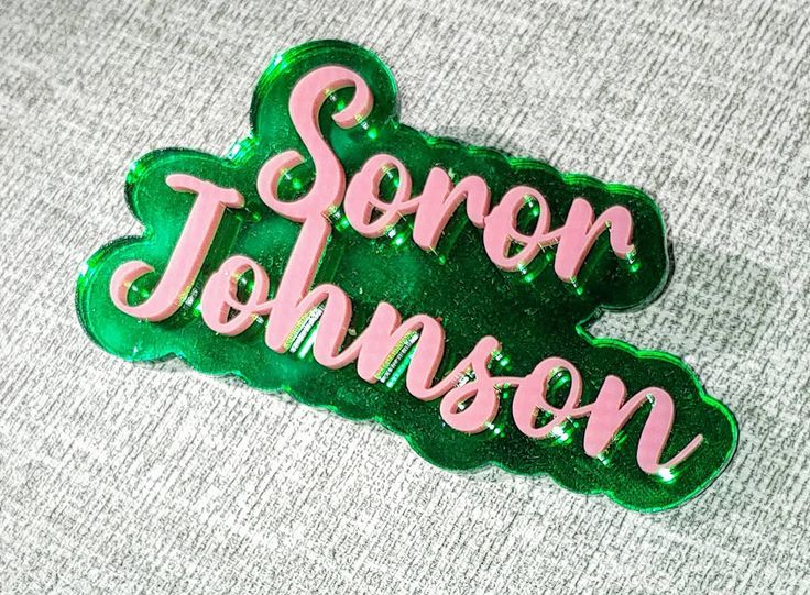 a green and pink sticker with the word sono johnson on it's side