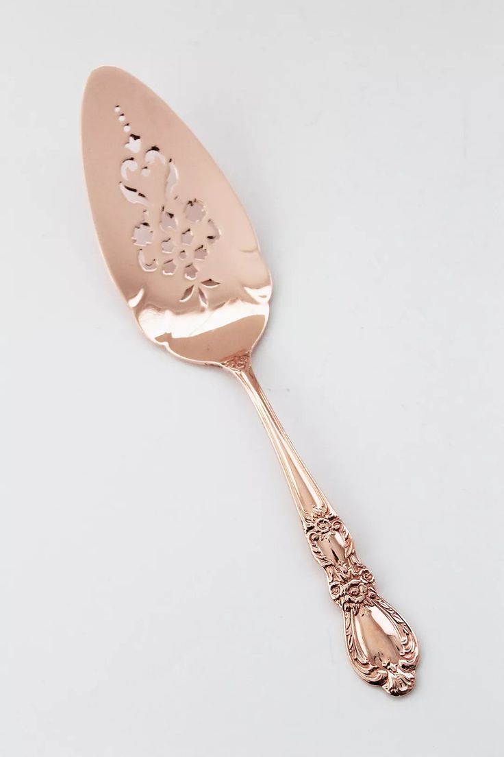 a gold spoon with an intricate design on it