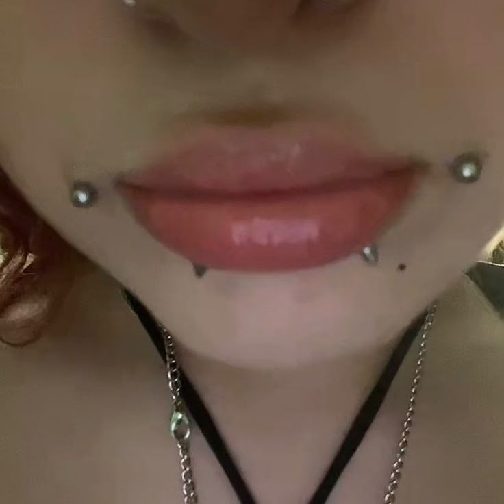 a woman with piercings on her nose and tongue