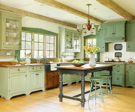 an old fashioned kitchen with green cabinets and wood flooring is pictured in this image