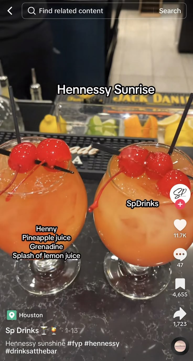 two glasses filled with drinks sitting on top of a counter next to an orange drink