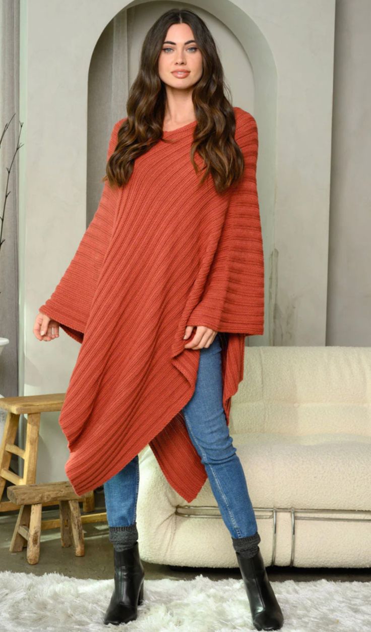 Enhance your wardrobe with our luxurious 'WOMEN'S RIBBED LONG PONCHO SWEATER', available in sizes Small to Large. Adorned with a ribbed pattern, this poncho exudes elegance and sophistication. Choose from our three color options - Mauve, Black, or Cream - to add a touch of beauty to any outfit. Whether you're heading out for a casual day or a glamorous evening, this poncho is the perfect accessory. Don't miss out on the chance to elevate your style and make a statement. Model is wearing size Sma Cozy Long Sleeve Poncho For Loungewear, Long Ribbed Sweater For Fall, Cozy Solid Color Poncho For Fall, Winter Long Sleeve Poncho For Layering, Fall Long Sleeve Poncho, Knit Long Sleeve Poncho For Fall, Cozy Long Sleeve Knit Poncho, Long Winter Poncho, Long Poncho