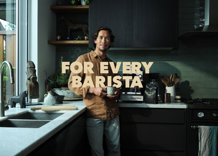 a man standing in front of a kitchen counter with the words for every barista on it