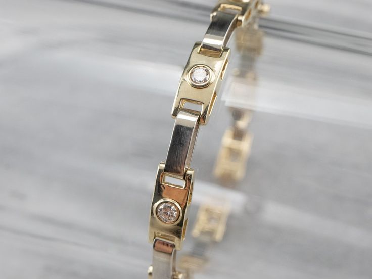 The proportions of this bracelet are excellent, with the sparkling bezel-set diamonds framed by elongated, polished gold bars. Incredibly proportioned, this gorgeous bracelet will transition easily from the office to the evening, making a wonderful gift that can be worn every day. Metal: 14K Yellow and White Gold Gem: 9 Diamonds totaling .72 Carats, SI1 in Clarity, H in Color Gem Measurements: 2.8 mm, Round Width: 6.0 mm Length: 7 Inches Marks: "14K" Stamped on the clasp Luxury Bezel Set Diamond Bracelet Gift, Luxury Adjustable Diamond Bracelet With Bezel Setting, Luxury Channel Set Diamond Bracelet, Timeless Gold Diamond Bracelet With Bezel Setting, Gold Diamond Bracelet With Rectangular Links For Formal Events, Formal Gold Bracelet With Bezel Setting, Gold Diamond Bracelet With Rectangular Links For Formal Occasions, Formal Fine Jewelry Gold Bracelet With Bezel Setting, Gold Bracelets With Single Cut Diamonds For Formal Occasions