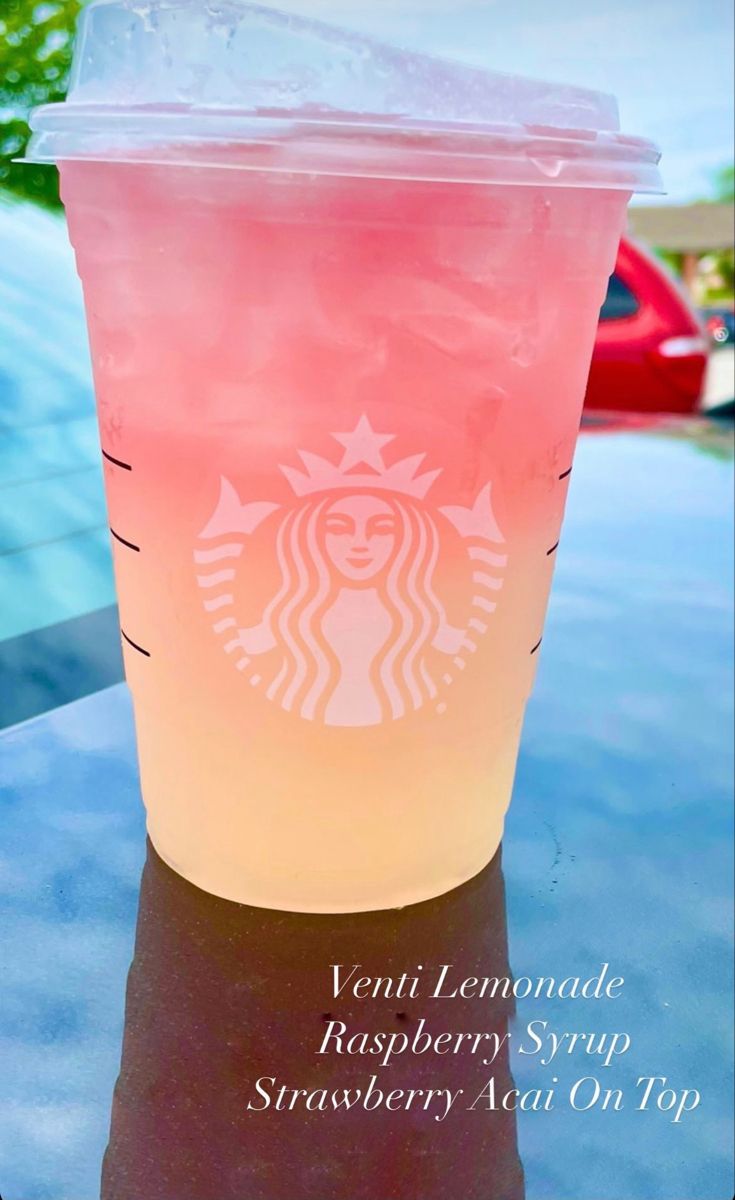 a pink drink sitting on top of a table