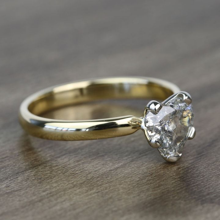 a close up of a diamond ring on a table