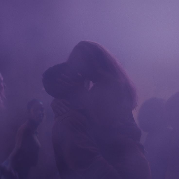 a group of people standing around in the fog