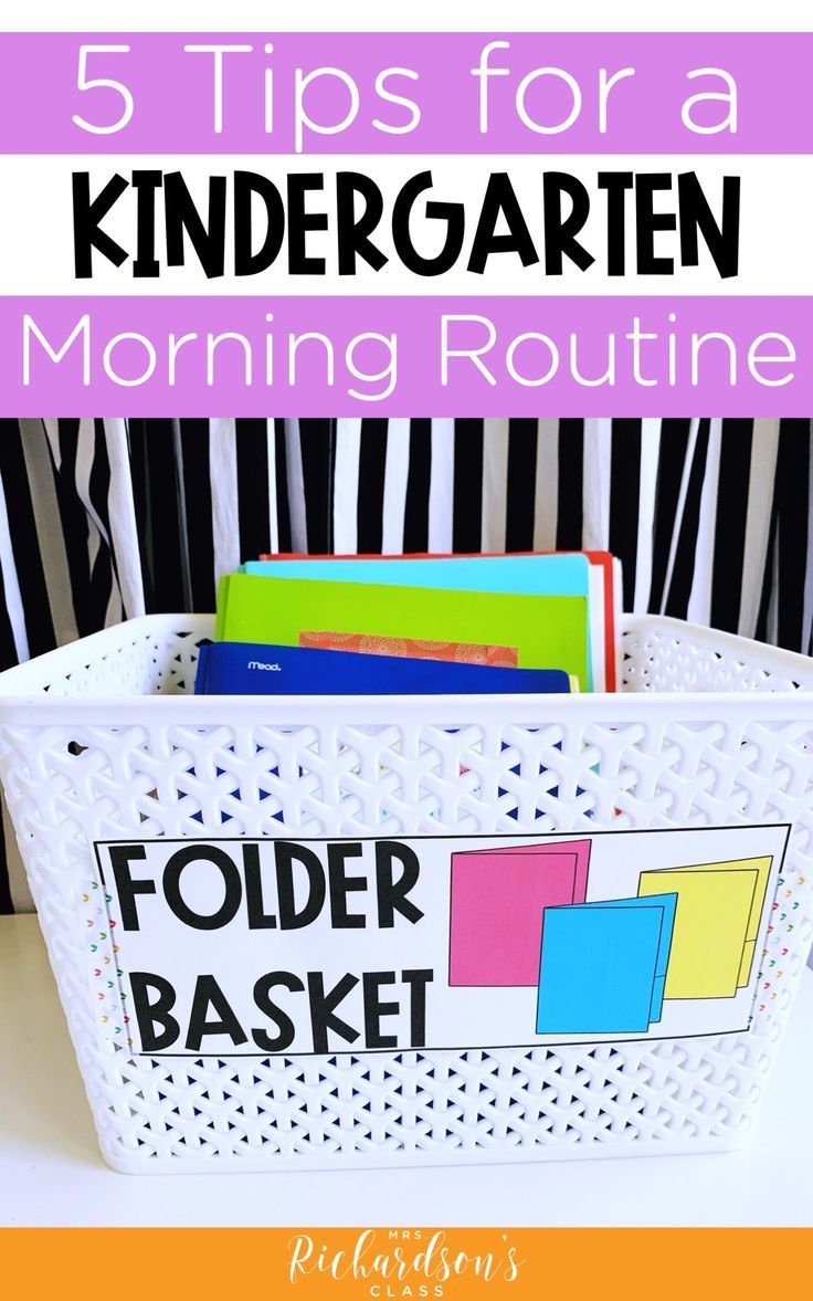 a basket filled with books and folders sitting on top of a table next to a striped