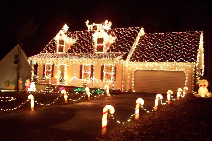 a house covered in christmas lights and candy canes