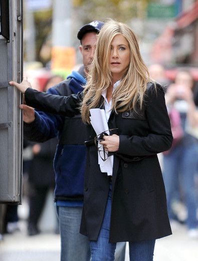 a woman standing next to a man on the street