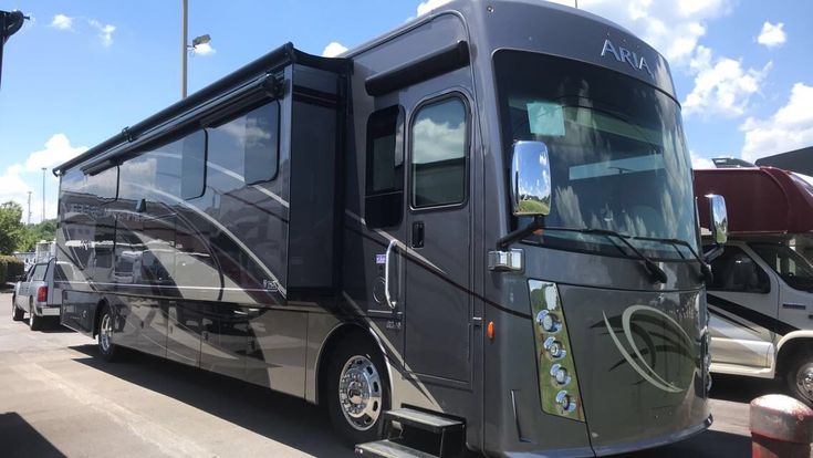 an rv parked in a parking lot next to other vehicles