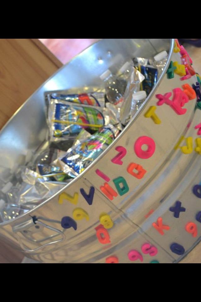 a metal bucket filled with lots of candy and confetti on top of a table