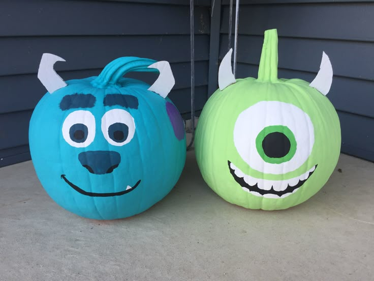 two pumpkins decorated to look like monsters