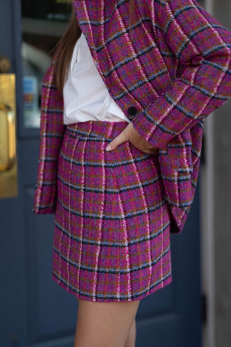 Expertly crafted with a flattering a-line silhouette, this pink plaid tweed skirt adds a touch of sophistication to any outfit! Details + Fit Dry Clean Only Fits true to size Model is 5’10” and wearing size small Relaxed Pink Skirt For Fall, Fall Pink Pleated Skirt, Pink Tweed Skirt For Spring, Spring Pink Tweed Skirt, Chic Pink Tweed Dress For Fall, Pink Skirt For Fall, Chic Plaid Skirt For Workwear, Chic Pink Tweed Skirt, Fall Pleated Pink Skirt