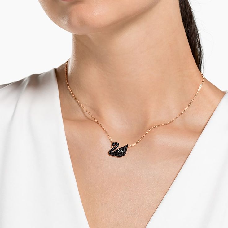 This elegant rhodium-plated pendant features Swarovski’s legendary swan motif. Delicately embellished with dramatic black crystals set in our innovative Pointiage® technique, it sparkles softly enough to complement any work or leisure outfit. The pendant measures 1 x 1 cm and the chain is 38 cm. Layer it with the rose gold-plated Iconic Swan Pendant for an on-trend mixed metal look. Article no.: 5347329 Length (minimum - maximum): 14.96 - 17.32 inch Motif size: 0.55 x 0.67 inch Material: Crystal Swan Jewelry, Swan Pendant, Swan Design, Swan Necklace, Swarovski Swan, Minimal Necklace, Swarovski Necklace, Wear Necklaces, Swarovski Jewelry